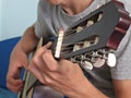 Practicing in playing guitar. Closeup of young men playing guitar Royalty Free Stock Photo