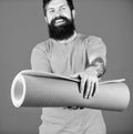 Practicing yoga every day. Man bearded athlete hold fitness mat. Fitness and stretching. Having good stretch. Athlete Royalty Free Stock Photo