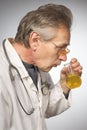 Practicioner in white gown determining disease with test tube of urine Royalty Free Stock Photo