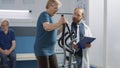 Practitioner assisting elder woman for rehabilitative physiotherapy Royalty Free Stock Photo