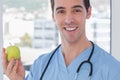 Practitioner holding a green apple Royalty Free Stock Photo