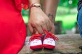 Couples holding baby shoe