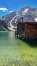 Pragser Wildsee lake in Italy and a small wooden house and mountains in the background Royalty Free Stock Photo