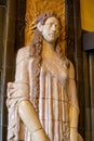 Vertical view of a ceramic bas-relief statue of a woman in the foyer of the iconic Art Deco