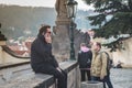 Prague, Bohemia / Czech Republic - November 2017: tourists near the Prague castle, man sitting and talking on the phone