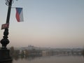 Prague castle early in the morning with the flag of the country