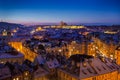 Prague Castle with snow rooftops during late christmas sunset with blue sky