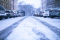 Prague city street under the snow. Cars driving on a blizzard road. Snow calamity in the city. Snow covered cars. Winter