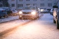 Prague city street under the snow. Cars driving on a blizzard road. Snow calamity in the city. Snow covered cars. Winter