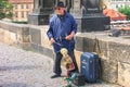 PRAGUE, CZECH - JULY 30, 2007 - An old puppet master with a puppet performing on the Charles Bridge over Vltava Royalty Free Stock Photo