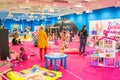 Prague, Czech Republic - April 27, 2023: Children playing in children's playroom with Barbie toys and Hot Wheels in