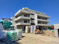 Construction site of concrete three story houses during sunny day