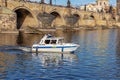 Police patrol boat on the Vltava River near Charles Bridge in Prague Royalty Free Stock Photo