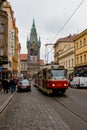 Red tram, tourists and Henry tower in Prague