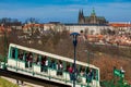 Tourists on the Petrin funicular with the Prague cathedral and city on background Royalty Free Stock Photo