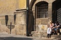 Prague, Czech Republic - April 19, 2011: A woman and a man sitting on gray stone staircase