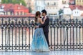 Prague, Czech Republic - April 20, 2019: Young asian couple at wedding photo session at the Charles bridge in Prague at sunrise,