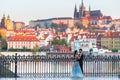 Prague, Czech Republic - April 20, 2019: Young asian couple at wedding photo session at the Charles bridge in Prague at sunrise,