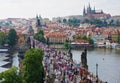 Prague, Czech Republic - August 14, 2016: Crowds of people walk on Charles Bridge - a popular tourist landmark. Prague townscape