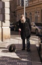 an old man with a dog on the tourist streets of Prague