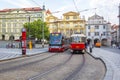 Old and modern trams on main square of Prague`s Mala Strana next to St. Nicholas Church Royalty Free Stock Photo