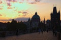 Stunning cityscape of Charles Bridge during sunrise. Statues on Charles Bridge, lanterns and Old Town Bridge Tower