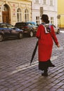 woman in red coat on the tourist streets of Prague