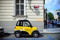 Prague, Czech Republic. August 28, 2018. Yellow mini electric car in the center of Prague.