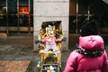 Prague, Czech Republic, December 24, 2016 - A funny clown an adult is disguised as a child in a stroller . Entertainment