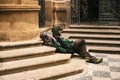 Prague, Czech Republic December 24, 2016 - Homeless hungry poor man sitting on the sidewalk in the city center. Unhappy Royalty Free Stock Photo