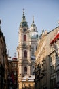 Prague, Czech Republic, 15 December 2022: View of Baroque Church of Saint Nicholas, green dome and bell tower with clock, sunny Royalty Free Stock Photo