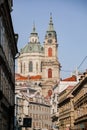 Prague, Czech Republic, 15 December 2022: View of Baroque Church of Saint Nicholas, green dome and bell tower with clock, sunny Royalty Free Stock Photo