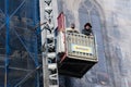 Workmen restoring ancient building Prague