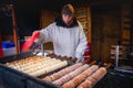 PRAGUE, CZECH REPUBLIC - FEBRUARY 19, 2013: preparation of the typical sweet Kurtoskalacs or kurtos kalacs