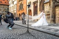 Prague, Czech Republic -January 20, 2020: Chinese photographer takes pictures of a wedding couple