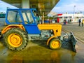 Prague, Czech Republic - January 2, 2018: The colorful tractor is parked near the gas station at Prague, Czech Republic Royalty Free Stock Photo
