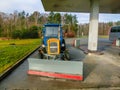 Prague, Czech Republic - January 2, 2018: The colorful tractor is parked near the gas station at Prague, Czech Republic Royalty Free Stock Photo