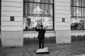 Prague, Czech Republic: an homeless violinist is playing on the sidewalk in front of a restaurant