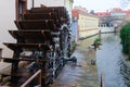 Mill Wheel of Velkoprzhevorskaya Mill and statue of Czech Water Kabourek on Chertovka River in Prague, Czech Republic Royalty Free Stock Photo