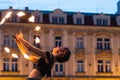 Prague, Czech Republic - July 22, 2019: Female fire dancer juggles with sticks on street of old town square in Prague. Fire show.