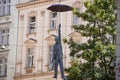 Hanging man with umbrella sculpture called Slight Uncertainity by Michal Trpak in Prague (