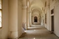 Prague, Czech Republic, 16 July 2023: Long white hallway of Invalidovna, baroque building for war veterans, Repeating pattern of