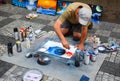 PRAGUE, CZECH REPUBLIC - JULY 17, 2017: A man paints pictures on the street, using paint spray cans of different colors