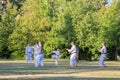 People doing sports, training karate, in famous Prague public park Letna in the center