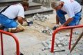 PRAGUE, CZECH REPUBLIC - JULY 18, 2017: Repairing sidewalk. Workers laying stone paving slabs. Royalty Free Stock Photo