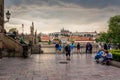 PRAGUE, CZECH REPUBLIC - JULY 1, 2018: Tourists looking at the Charles Bridge and Prague Castle in Prague during Sunset, Royalty Free Stock Photo