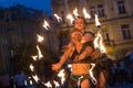 Prague, Czech Republic - July 22, 2019: Two Female fire dancers on street of old town square in Prague. Fire show. Fascinating