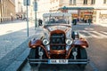 Prague, Czech Republic - June 03, 2017: classic car parked along street side. Vintage sightseeing vehicle. City tour Royalty Free Stock Photo