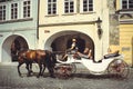 Historical architecture tourists ride horses in carriages. Prague, Czech Republic Royalty Free Stock Photo