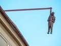 Man Hanging Out Statue in Prague